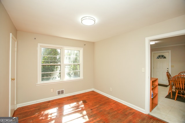 unfurnished room with wood-type flooring