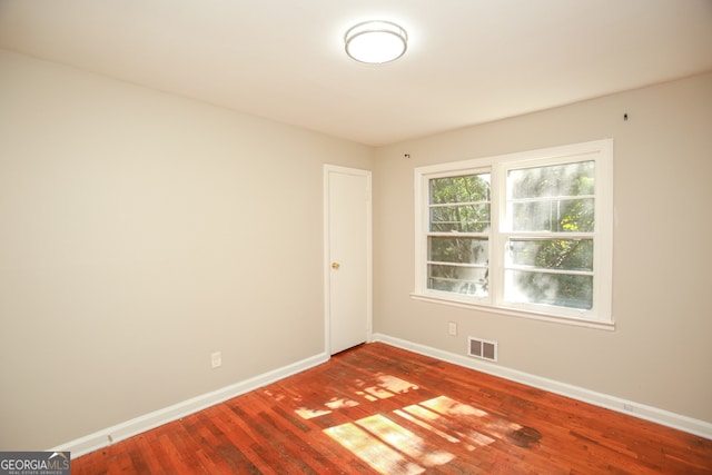 empty room with hardwood / wood-style floors