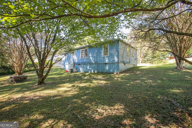 view of side of home featuring a yard