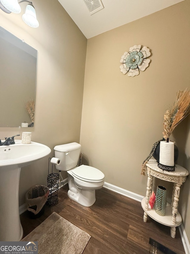 bathroom featuring hardwood / wood-style floors and toilet