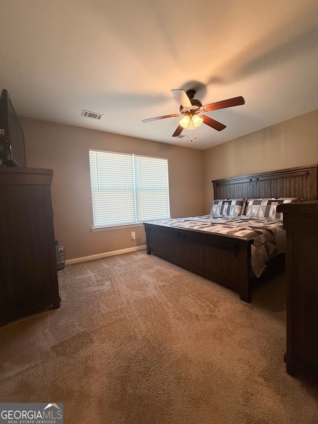 bedroom featuring light carpet and ceiling fan