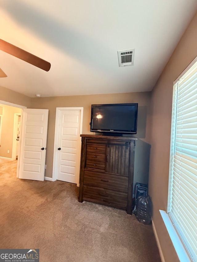 unfurnished bedroom featuring ceiling fan and light colored carpet