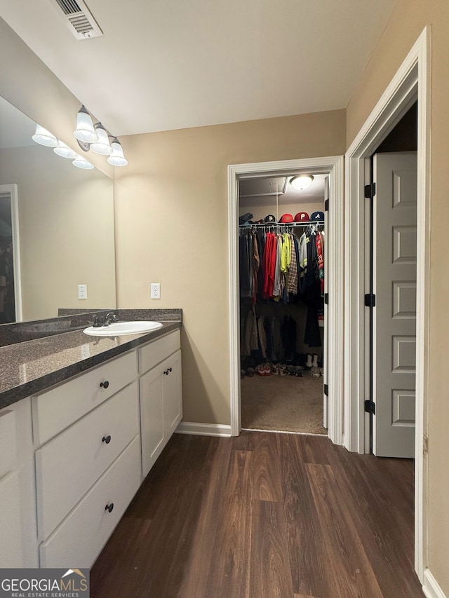 bathroom with vanity and hardwood / wood-style floors