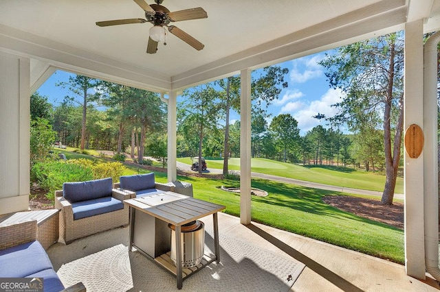 sunroom featuring ceiling fan