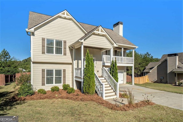 view of front of home with a front lawn, a porch, and a garage