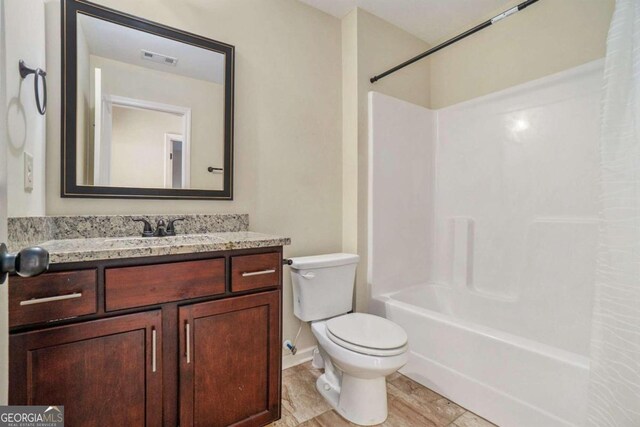 full bathroom featuring shower / tub combination, vanity, and toilet