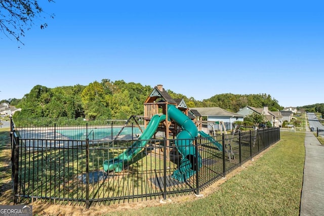 view of play area featuring a fenced in pool and a lawn