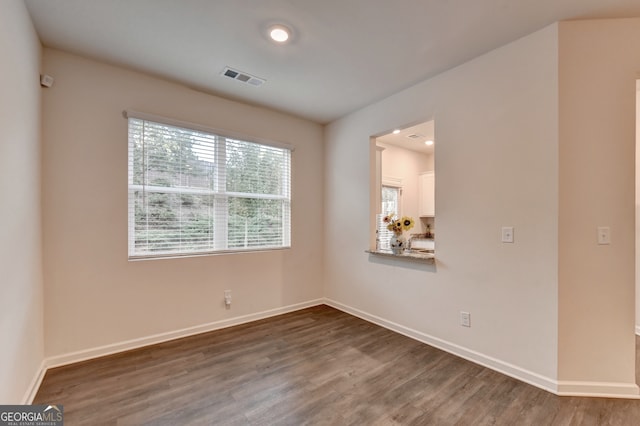 spare room featuring dark wood-type flooring