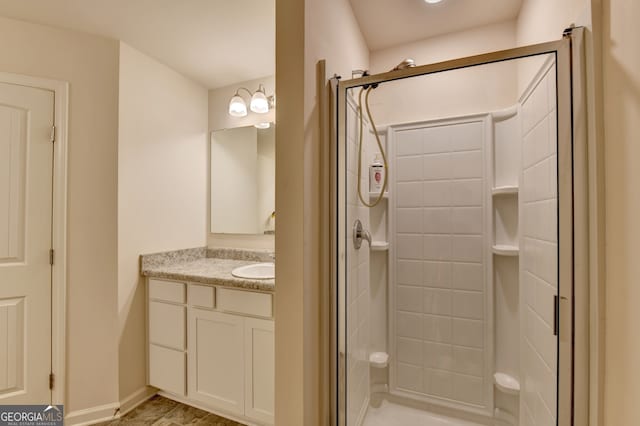 bathroom with walk in shower and vanity