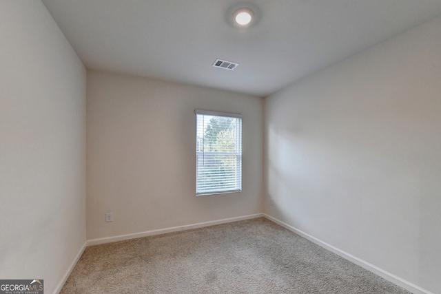 unfurnished room with light carpet