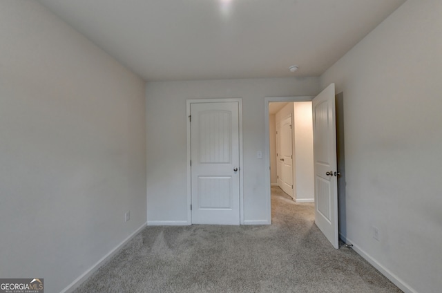 unfurnished bedroom with light colored carpet