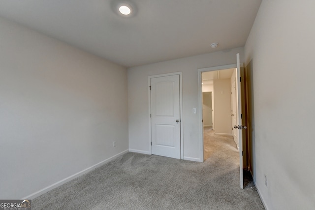 unfurnished bedroom featuring light carpet