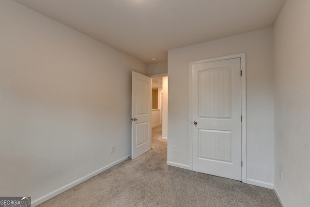 unfurnished bedroom with light carpet