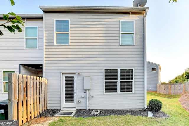 rear view of house featuring a yard