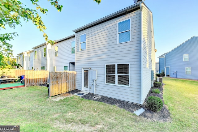 rear view of house with a yard