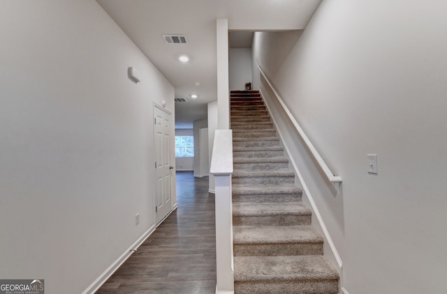 stairway with hardwood / wood-style flooring