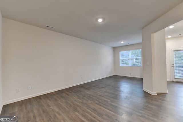 unfurnished room featuring dark hardwood / wood-style flooring