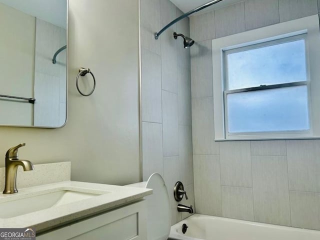 bathroom featuring a wealth of natural light, vanity, and tiled shower / bath combo