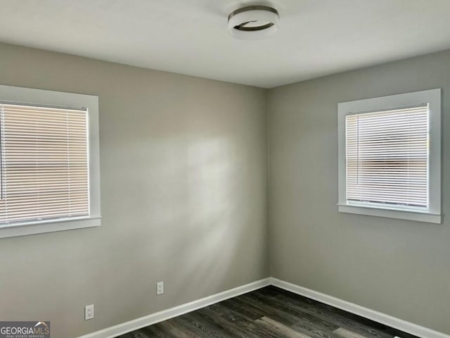 unfurnished room featuring dark hardwood / wood-style flooring