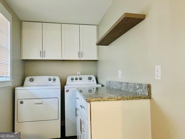 laundry room with washer and clothes dryer and cabinets