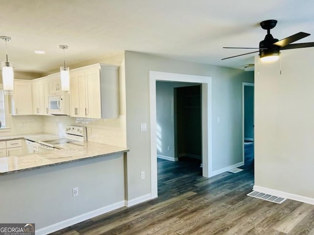 kitchen featuring light stone countertops, dark hardwood / wood-style floors, white appliances, hanging light fixtures, and white cabinetry