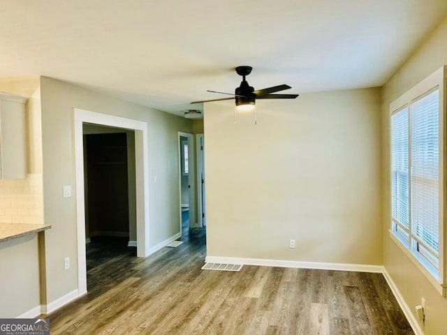 empty room featuring wood-type flooring and ceiling fan