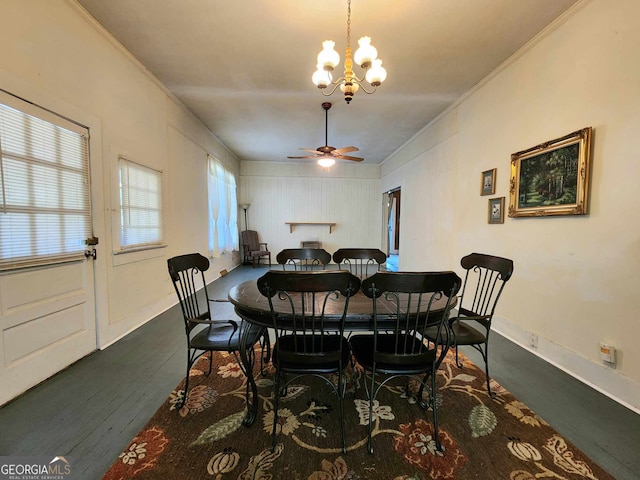 dining room featuring ornamental molding, hardwood / wood-style floors, and ceiling fan with notable chandelier