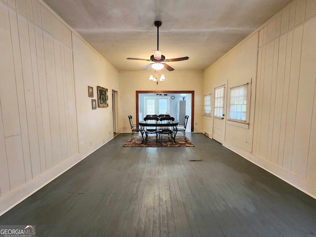 unfurnished dining area featuring ceiling fan, dark hardwood / wood-style floors, and crown molding