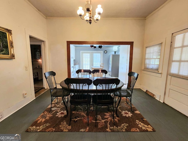 dining space featuring ornamental molding, plenty of natural light, and dark hardwood / wood-style floors