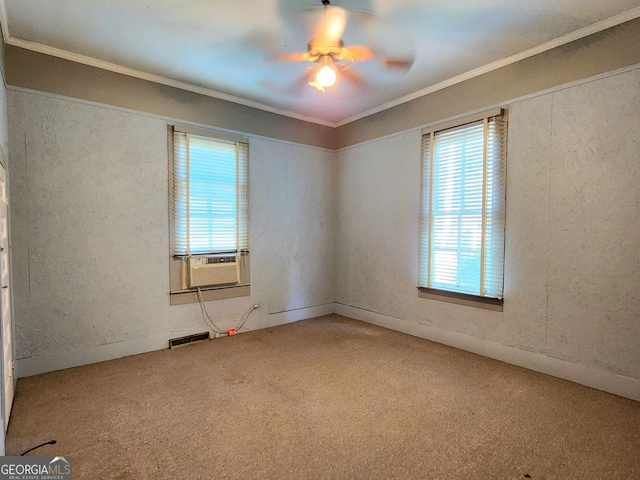 spare room featuring ceiling fan, crown molding, cooling unit, and carpet floors