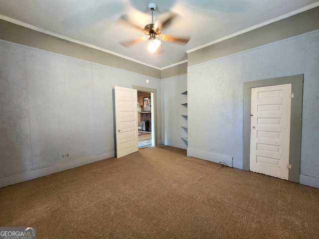 unfurnished bedroom featuring carpet floors, ornamental molding, and ceiling fan