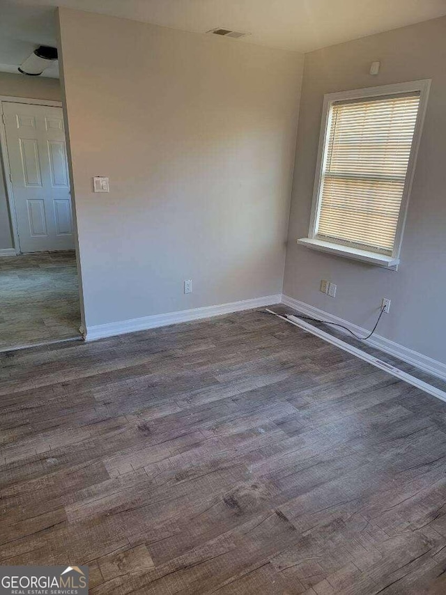 spare room with dark hardwood / wood-style flooring