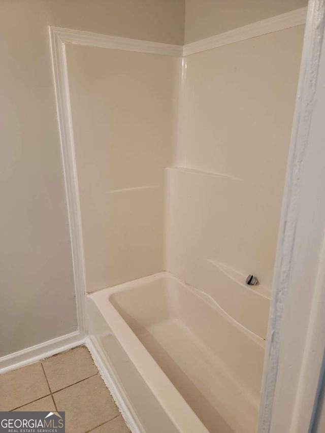 bathroom featuring a bath and tile patterned floors