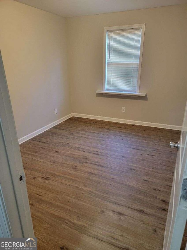 empty room featuring dark hardwood / wood-style flooring