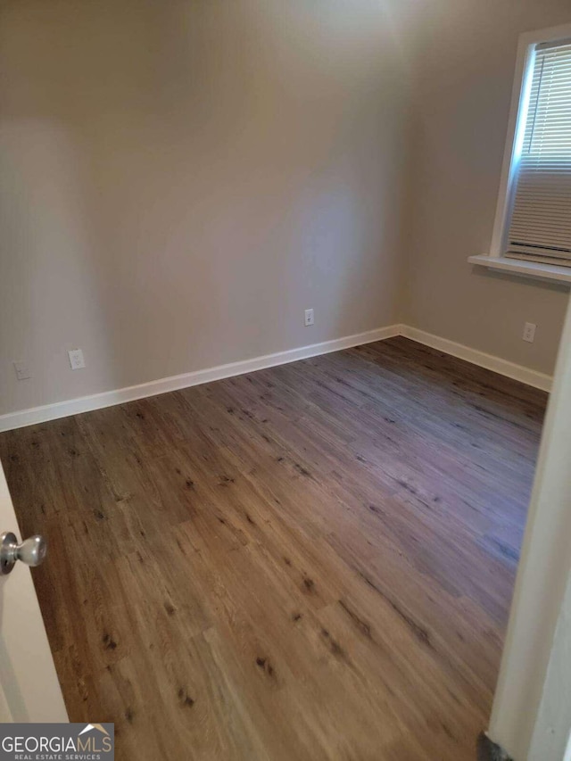 unfurnished room featuring dark hardwood / wood-style floors