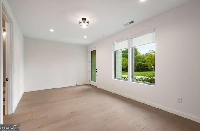 unfurnished room with light hardwood / wood-style flooring