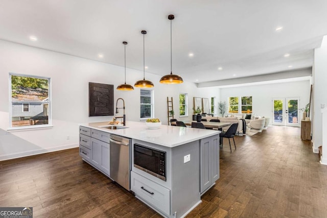 kitchen featuring dishwasher, a sink, recessed lighting, gray cabinets, and built in microwave