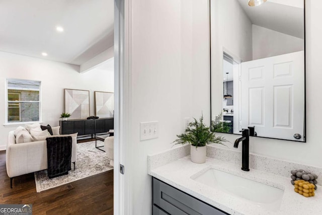 bathroom featuring wood finished floors, vanity, and recessed lighting