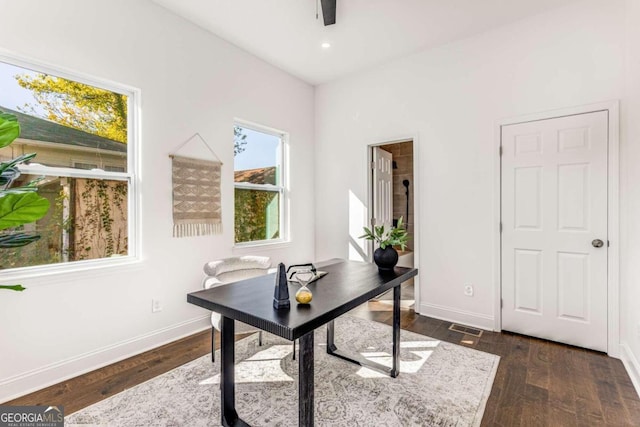 office featuring dark wood-type flooring, baseboards, visible vents, and recessed lighting
