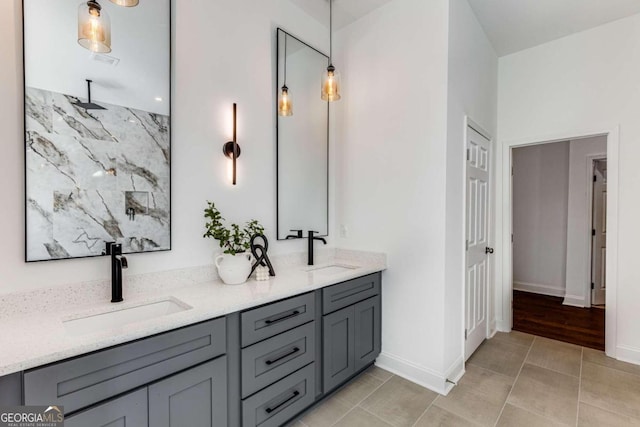 bathroom with double vanity, a sink, and tile patterned flooring