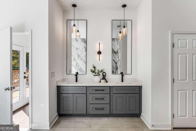 bathroom with tile patterned flooring, vanity, and french doors