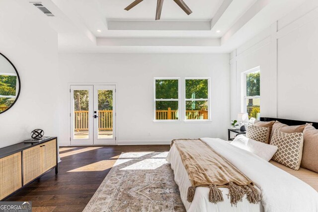 bedroom featuring french doors, dark wood-type flooring, access to exterior, and multiple windows