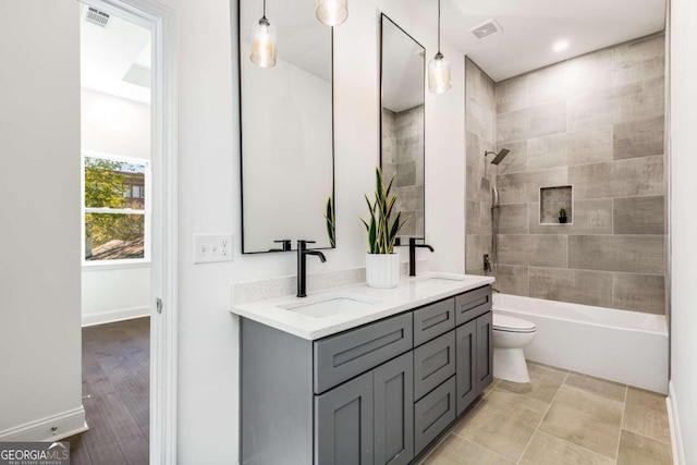 bathroom with a sink, visible vents, and double vanity