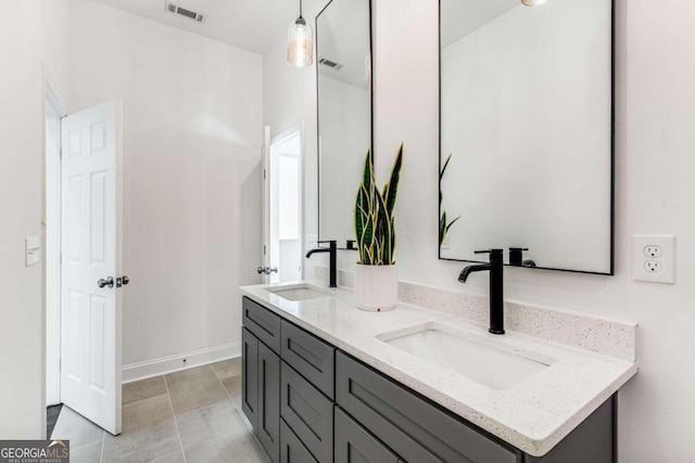 bathroom with a sink, visible vents, and double vanity