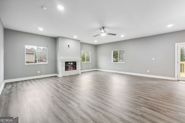 397 S Gordon Rd SW, Mableton, GA 30126 - unfurnished living room featuring a ceiling fan, recessed lighting, wood finished floors, a glass covered fireplace, and baseboards