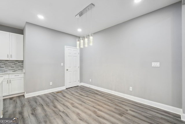 397 S Gordon Rd SW, Mableton, GA 30126 - unfurnished dining area with recessed lighting, light wood-style floors, and baseboards