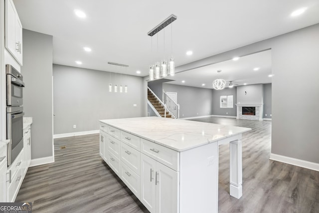 397 S Gordon Rd SW, Mableton, GA 30126 - kitchen with a center island, recessed lighting, dark wood-type flooring, and white cabinetry