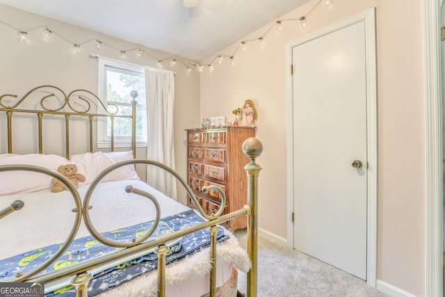 bedroom featuring lofted ceiling and light colored carpet