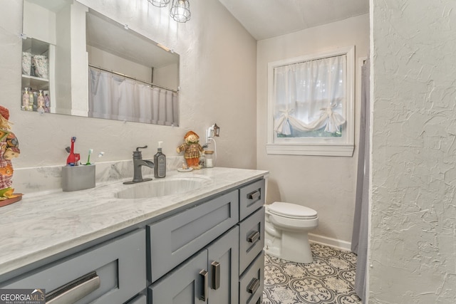 bathroom featuring a textured wall, vanity, and tile patterned floors