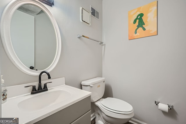 bathroom featuring toilet and vanity